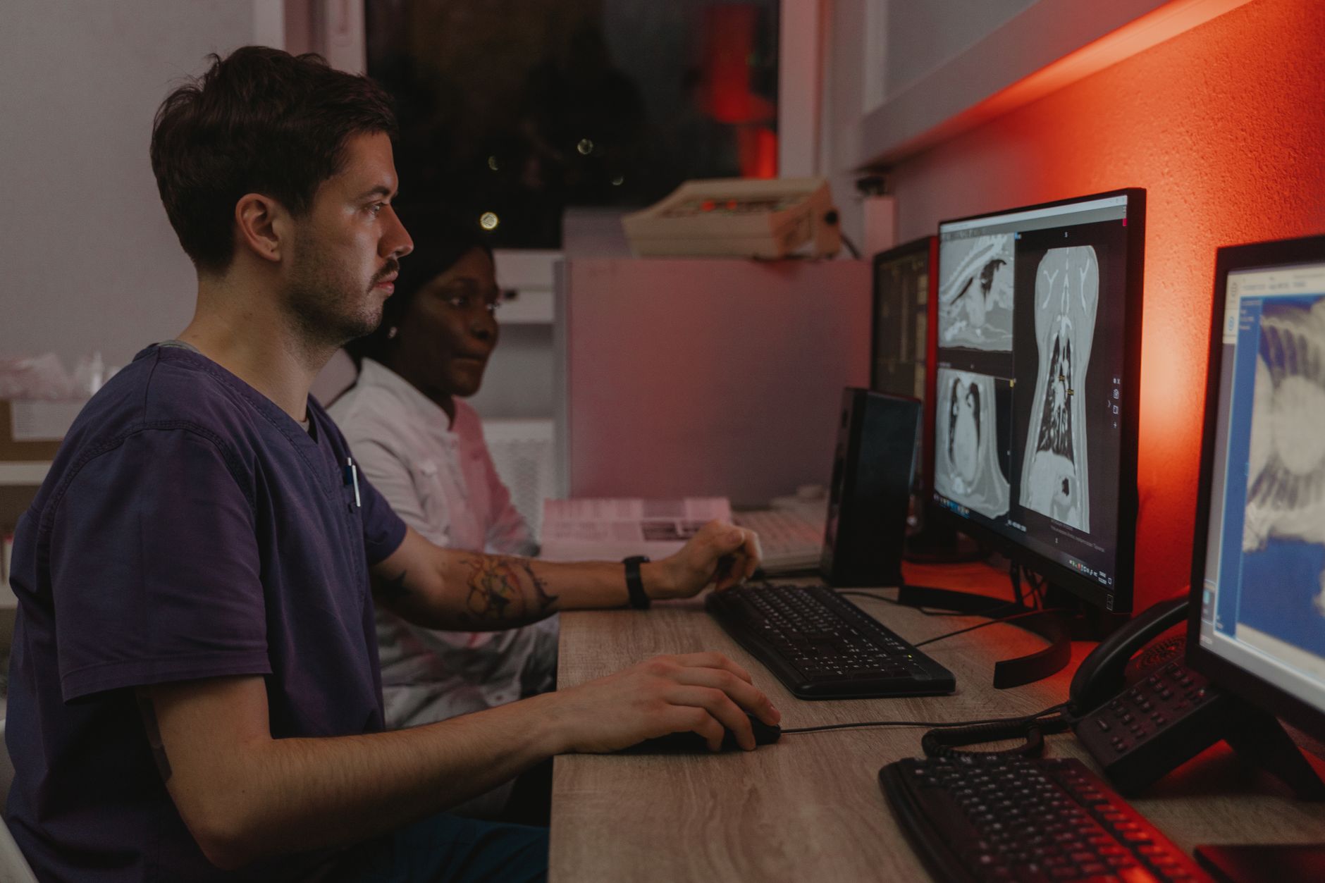 Veterinary staff reviewing X-ray images on a monitor